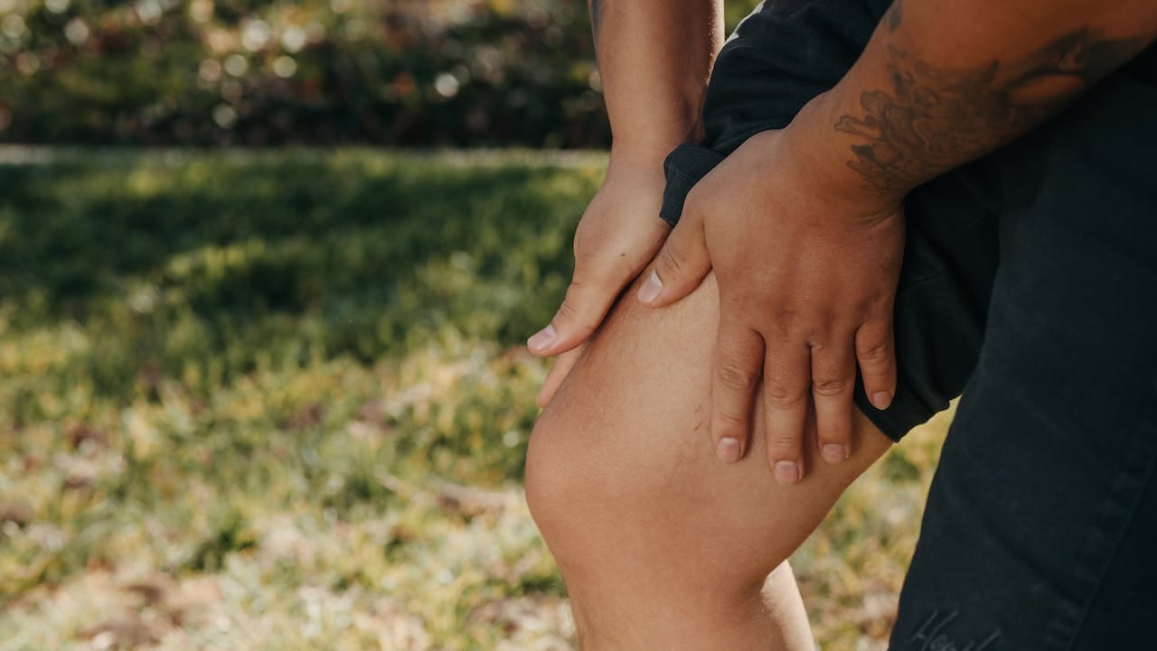 a person holding his leg